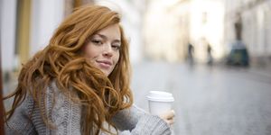 Young Redheaded Woman with Coffee To Go