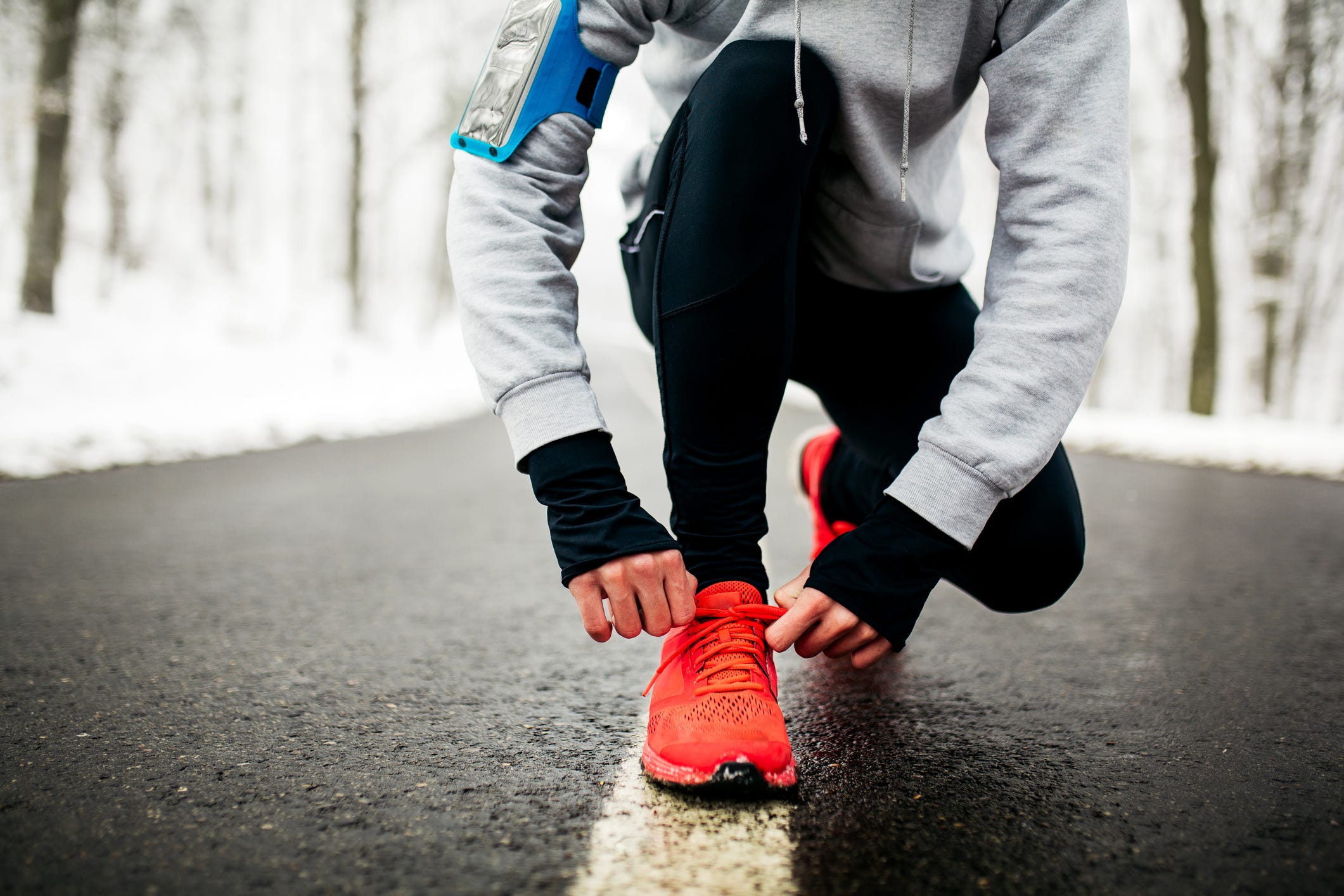 Young runner tying his shoelaces
