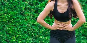 young sport woman having pain at her stomach