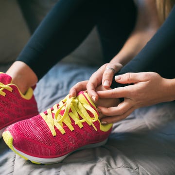 young sport woman with injured ankle