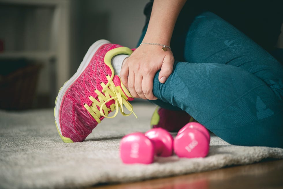 young sport woman with injured ankle