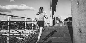 young sports woman running over bridge in berlin