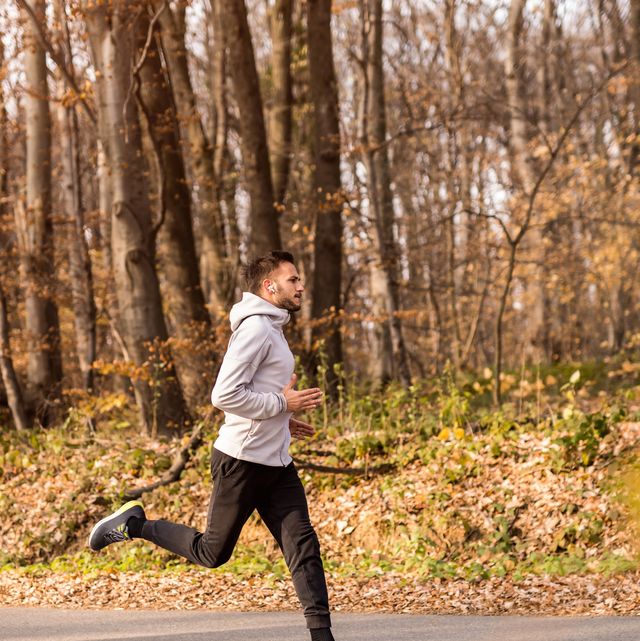 young sportsman running on scenic road