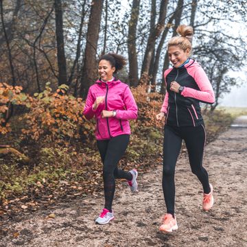 young sportswomen running in nature on foggy morning