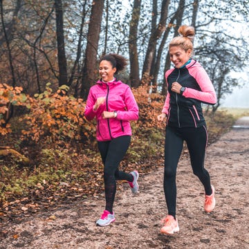 young sportswomen running in nature on foggy morning