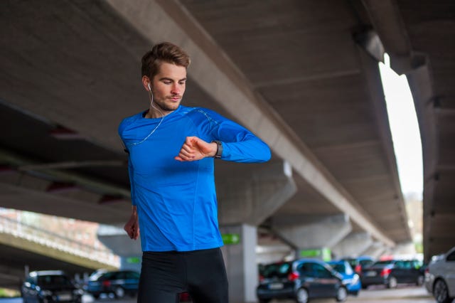 young sporty man checking his smart watch