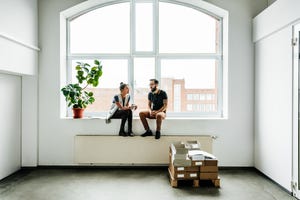 young start up business people sitting in a window and talking