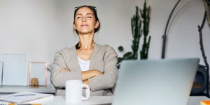 young woman at home with laptop on desk having a break