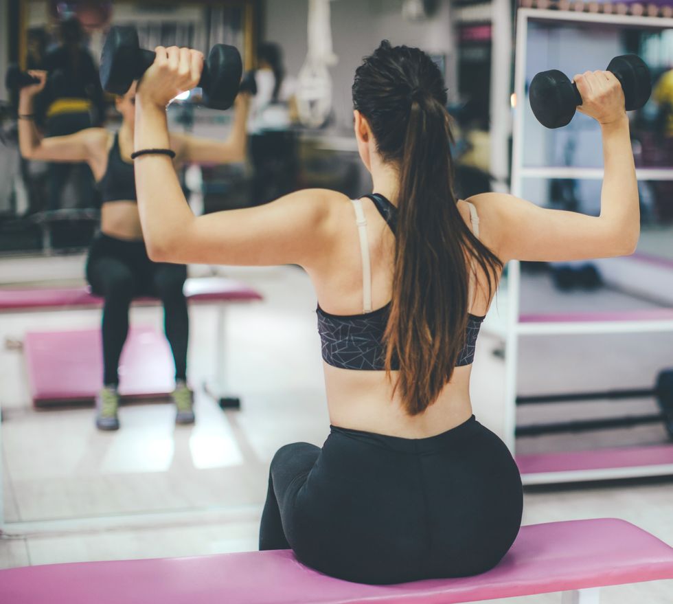 young woman athlete working out at the gym