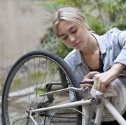 young woman cleaning her bicycle