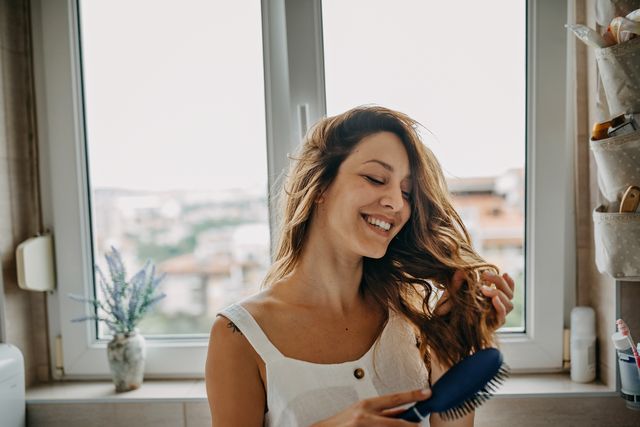 young woman combing hair