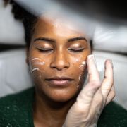 young woman doing a facial treatment at a spa