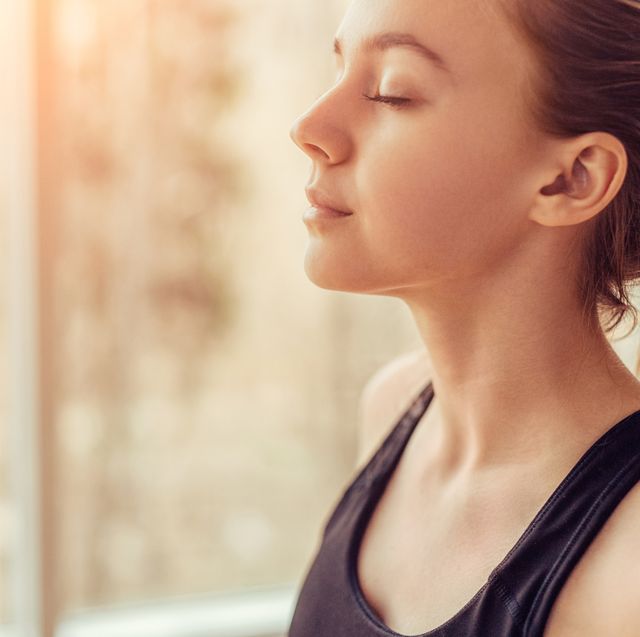 young woman doing breathing exercise