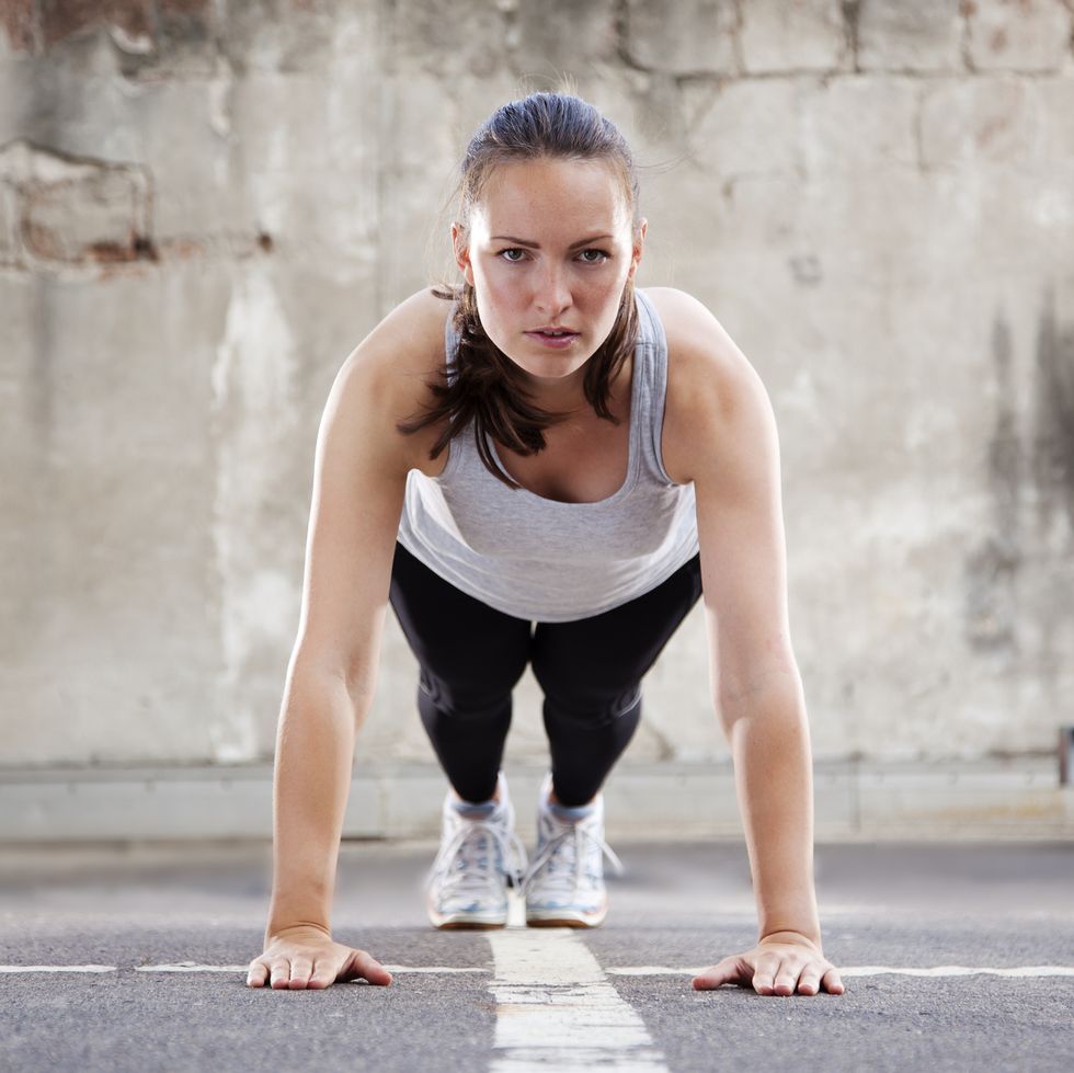 young woman doing burpee exercise