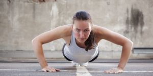 Young woman doing Burpee exercise
