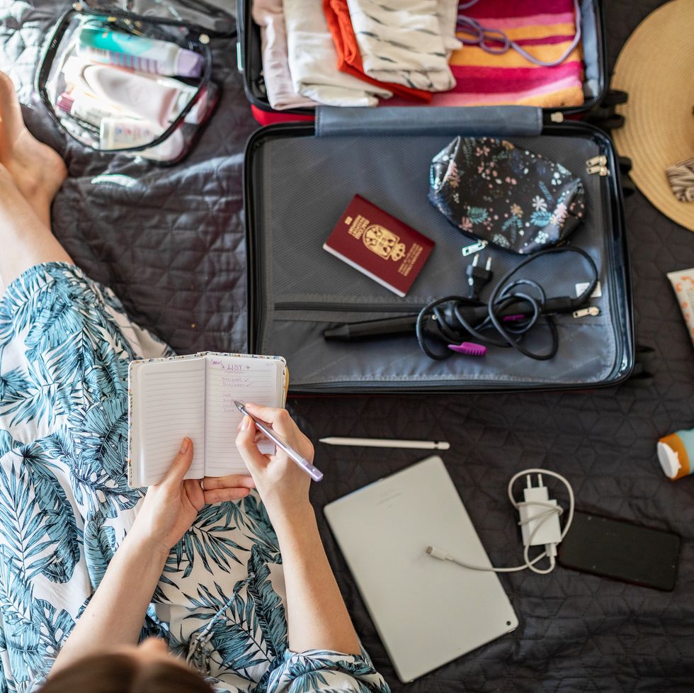 young woman doing her last check to be sure if she have everything she needs for vacation