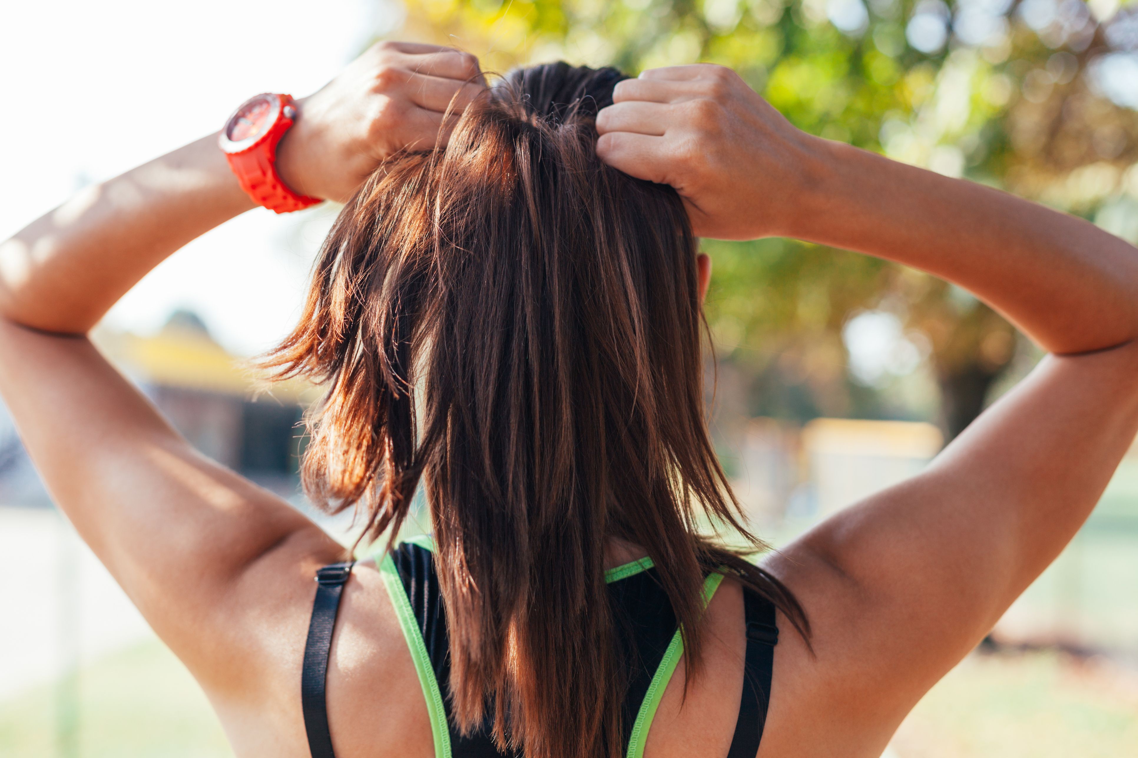 Young woman doing some warm-up exercises before running.