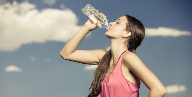 Young Woman Drinking From Water Bottle