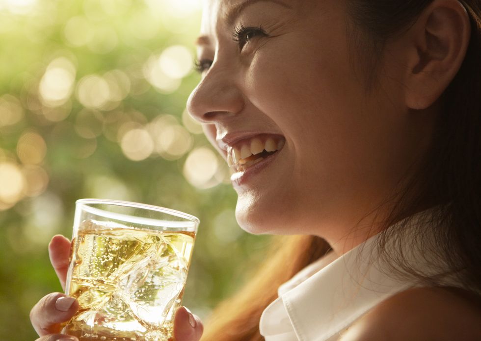 young woman drinking highball