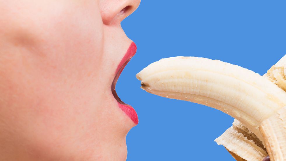 Young woman eating a banana