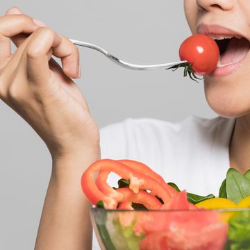 young woman eating a salad