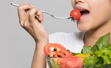 young woman eating a salad