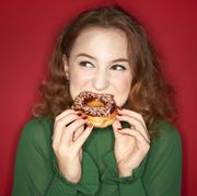 young woman eating donut