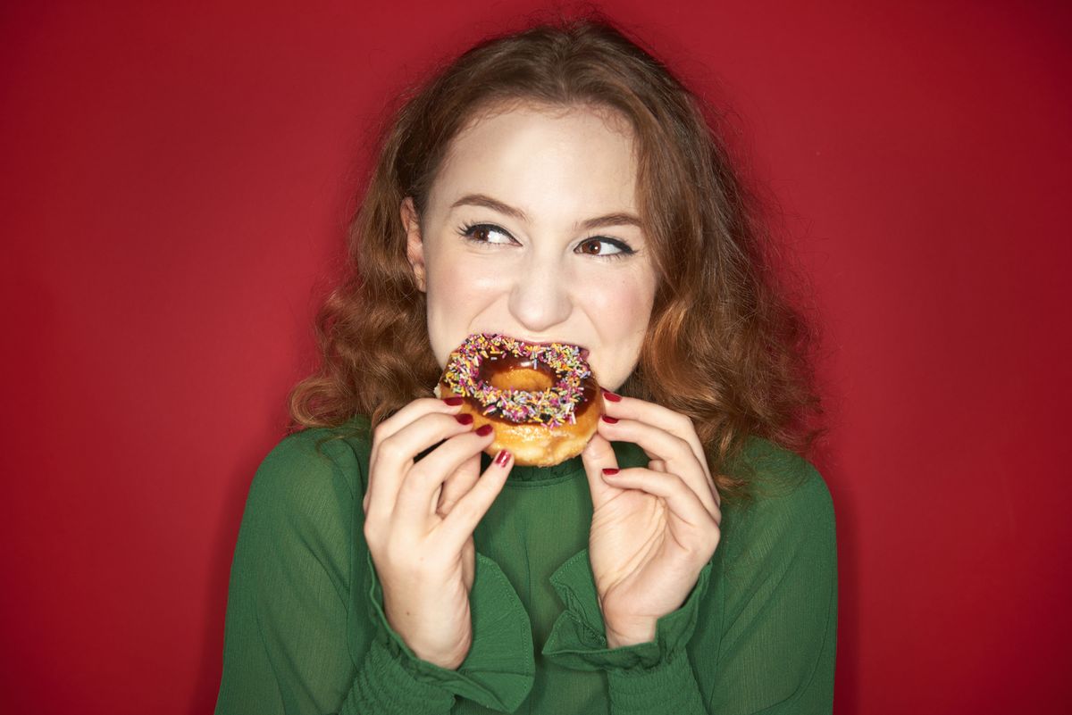 young woman eating donut