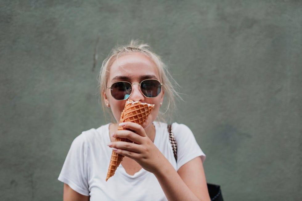 young woman eating ice cream cone