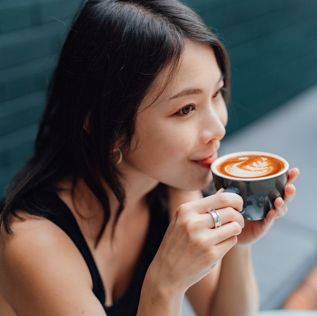 young woman enjoying a peaceful morning with a cup of coffee in cafe