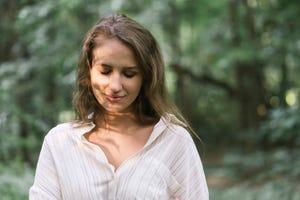 young woman enjoying the forest