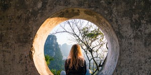 young woman enjoys view over yangshuo, karst mountains