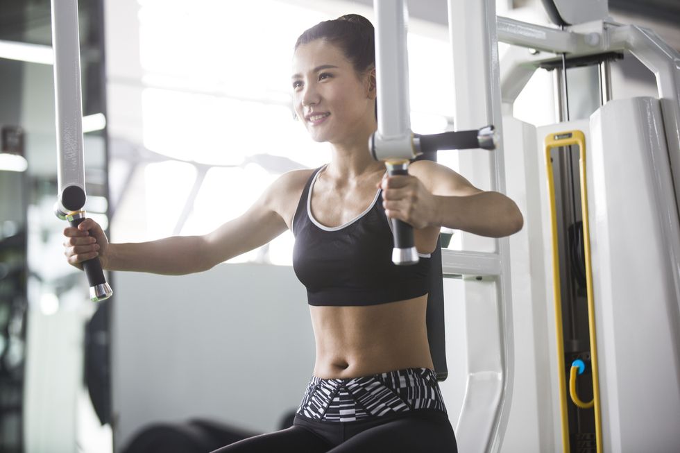 young woman exercising at gym