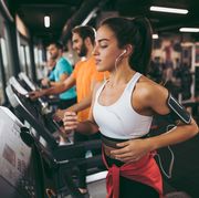 Young woman exercising on treadmill