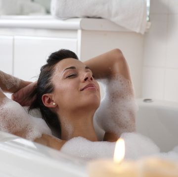 young woman in bubble bath, smiling