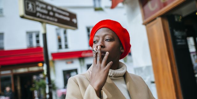 Young woman in Paris smoking a cigarette