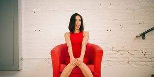 young woman in red on red armchair