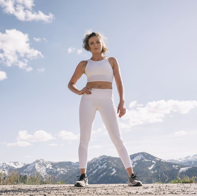 young woman in workout clothing in mountain setting