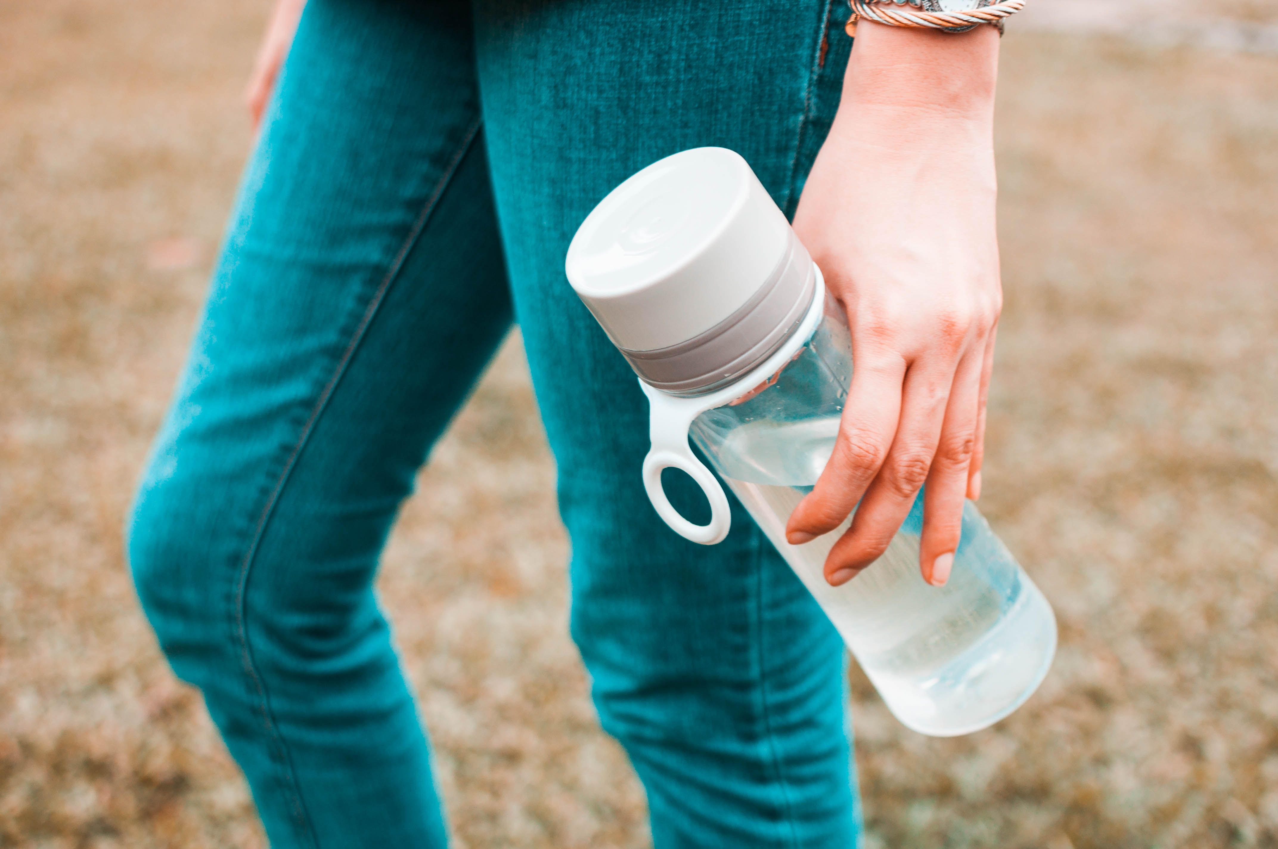 https://hips.hearstapps.com/hmg-prod/images/young-woman-is-holding-a-reusable-water-bottle-royalty-free-image-1703186804.jpg