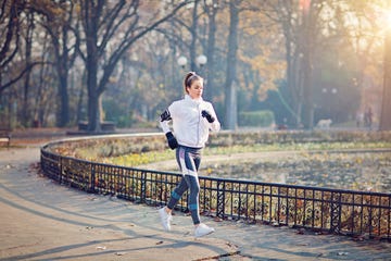 young woman is running in the cold autumn morning