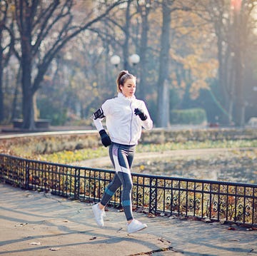 Young woman is running in the cold autumn morning young woman is running in the cold autumn morning