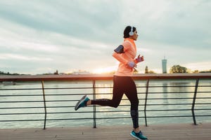 young woman jogging near river