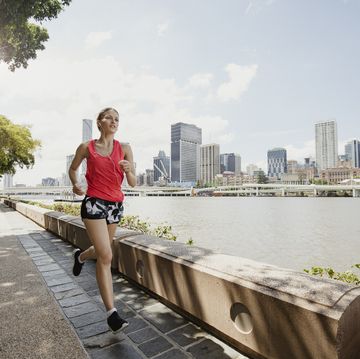 young woman jogging on brisbane southbank