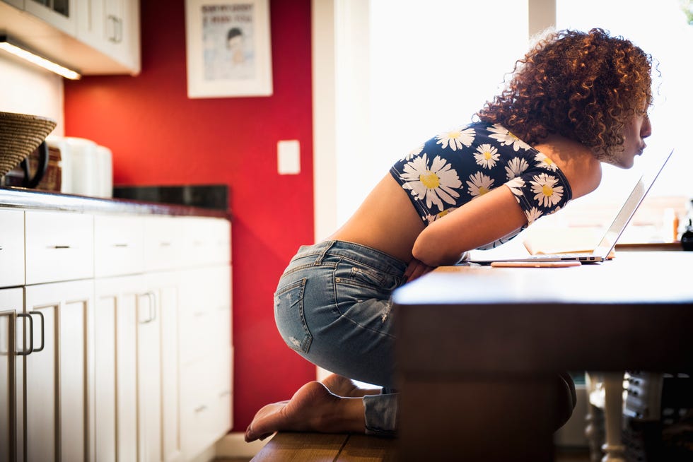 Young woman kissing laptop