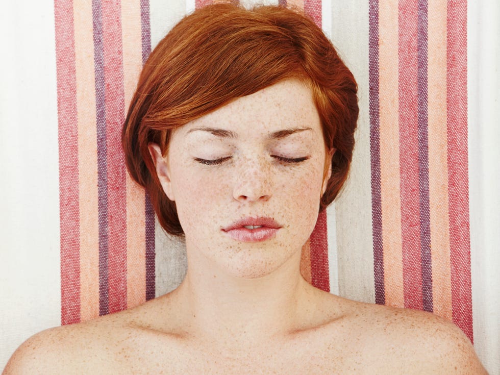 young woman laying with eyes closed