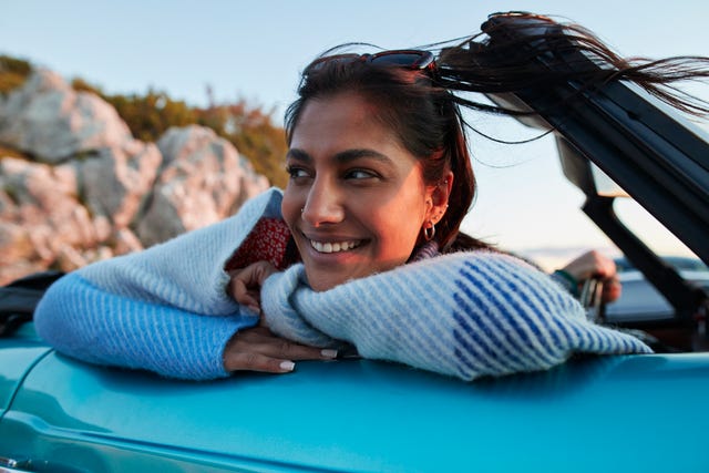 https://hips.hearstapps.com/hmg-prod/images/young-woman-leaning-on-car-during-vacation-royalty-free-image-1728336634.jpg?crop=1.00xw:0.753xh;0,0.0513xh&resize=640:*