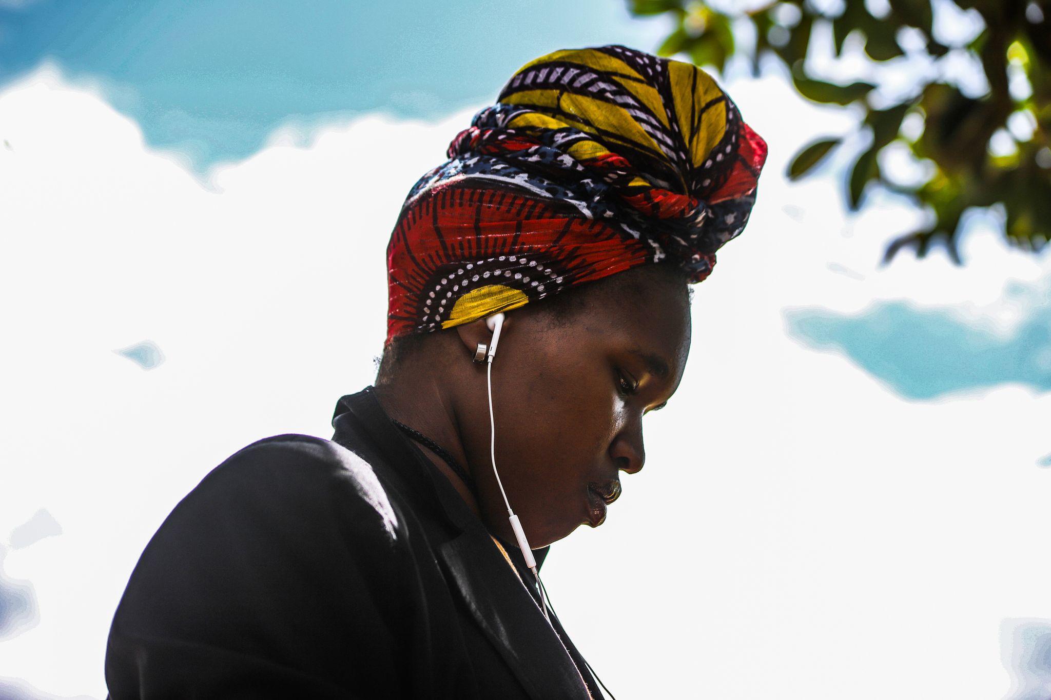 A young woman listening to music on her earphone