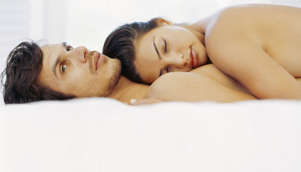 young woman lying on top of a young man