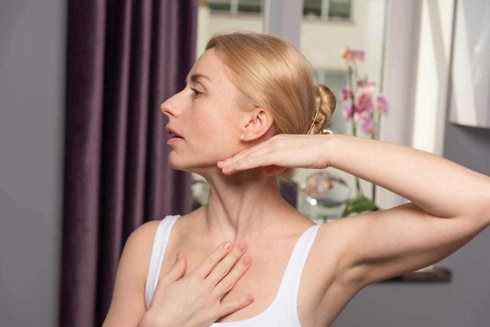 a young woman makes a face self massage for the effect of lifting and rejuvenation