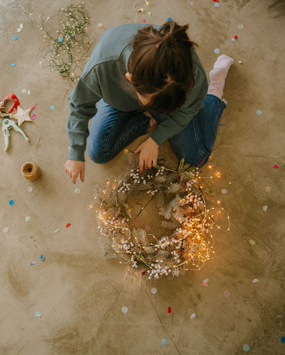 Young woman making a Christmas wreath young woman making a christmas wreath